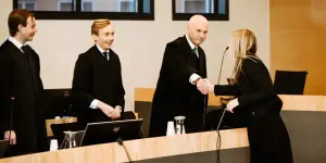 Counsel for the State of Norway makes a point of shaking hands with counsel for Jehovah's Witnesses